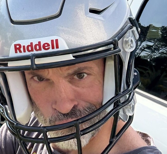 Adam LaBare wearing a football helmet, ready for a challenge